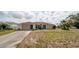 Charming single-story home with a two-car garage and manicured lawn at 1034 Aladdin Rd, Spring Hill, FL 34609