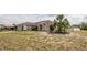 A single-story home, with a well-maintained front yard featuring mature landscaping and an attached garage at 1034 Aladdin Rd, Spring Hill, FL 34609