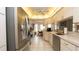 Spacious kitchen with stainless steel appliances, white cabinets and tiled floors at 1034 Aladdin Rd, Spring Hill, FL 34609