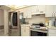 Bright kitchen features white cabinets, stainless steel appliances, and ample counter space at 1034 Aladdin Rd, Spring Hill, FL 34609