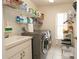 Laundry room featuring washer, dryer, sink, and wire shelving at 1034 Aladdin Rd, Spring Hill, FL 34609
