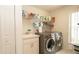 Laundry room featuring washer, dryer, sink, and wire shelving at 1034 Aladdin Rd, Spring Hill, FL 34609