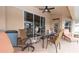 Covered patio area with a ceiling fan, plenty of seating, and sliding glass doors to the home's interior at 1034 Aladdin Rd, Spring Hill, FL 34609