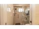 Accessible shower with sliding glass doors, grab bar, seat, and shower head at 1034 Aladdin Rd, Spring Hill, FL 34609