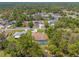 An aerial view reveals a private backyard pool and screened enclosure surrounded by lush, mature trees at 10540 Noddy Tern Rd, Weeki Wachee, FL 34613