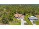 Aerial view showcases a charming home with well-manicured lawn and a detached garage at 10540 Noddy Tern Rd, Weeki Wachee, FL 34613