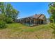 Expansive fenced backyard with a screened pool and patio, ideal for outdoor living and entertaining at 10540 Noddy Tern Rd, Weeki Wachee, FL 34613