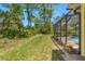 Spacious backyard featuring vibrant green grass, mature trees and pool, creating a private oasis at 10540 Noddy Tern Rd, Weeki Wachee, FL 34613
