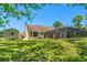 Lush backyard with well-maintained lawn, shed, and mature trees offering privacy and space at 10540 Noddy Tern Rd, Weeki Wachee, FL 34613