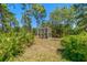 An enclosed backyard screened enclosure offers privacy and protection for gardening and outdoor enjoyment at 10540 Noddy Tern Rd, Weeki Wachee, FL 34613