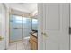 Bathroom featuring tiled floors, a vanity, toilet, and shower with glass doors at 10540 Noddy Tern Rd, Weeki Wachee, FL 34613