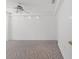 Spacious bedroom with neutral carpet, track lighting, and a ceiling fan at 10540 Noddy Tern Rd, Weeki Wachee, FL 34613