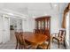 Bright dining room featuring a wood table, china cabinet, and neutral carpet at 10540 Noddy Tern Rd, Weeki Wachee, FL 34613