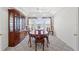 Dining room with a wooden table, china cabinet and large bright windows at 10540 Noddy Tern Rd, Weeki Wachee, FL 34613