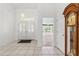 Bright foyer with tiled flooring, double doors, and view into the living room at 10540 Noddy Tern Rd, Weeki Wachee, FL 34613