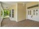 Covered front porch area featuring a double door entry and tiled flooring for a welcoming entrance at 10540 Noddy Tern Rd, Weeki Wachee, FL 34613