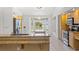 Bright kitchen with granite countertops, wood cabinets, stainless steel appliances and breakfast nook at 10540 Noddy Tern Rd, Weeki Wachee, FL 34613