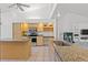 Open concept kitchen featuring granite countertops, kitchen island, stainless appliances, and eat-in counter at 10540 Noddy Tern Rd, Weeki Wachee, FL 34613