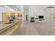 Open concept living room featuring fireplace with build in shelving and access to kitchen at 10540 Noddy Tern Rd, Weeki Wachee, FL 34613