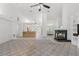 Spacious living area with high ceilings, fireplace, and open access to the kitchen and front entrance at 10540 Noddy Tern Rd, Weeki Wachee, FL 34613