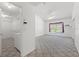 Bright main bedroom features a large walk-in closet, plush carpeting, and a ceiling fan at 10540 Noddy Tern Rd, Weeki Wachee, FL 34613
