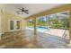 Large covered patio with tile flooring and view of the beautiful screened-in pool area at 10540 Noddy Tern Rd, Weeki Wachee, FL 34613