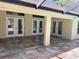 Tiled covered patio, with access to the pool and backyard area through glass doors at 10540 Noddy Tern Rd, Weeki Wachee, FL 34613