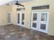 Covered outdoor patio featuring a ceiling fan and tiled flooring, perfect for relaxation and entertaining at 10540 Noddy Tern Rd, Weeki Wachee, FL 34613