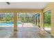 The covered patio provides a view of the pool with a cascading waterfall feature at 10540 Noddy Tern Rd, Weeki Wachee, FL 34613