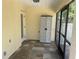 Enclosed outdoor porch with tiled flooring and a storage cabinet for added convenience at 10540 Noddy Tern Rd, Weeki Wachee, FL 34613