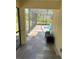 Screened-in porch with tiled flooring, offering an ideal space to relax with a view of the pool at 10540 Noddy Tern Rd, Weeki Wachee, FL 34613