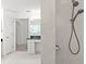 Main bathroom view showcasing the shower, vanity, and glass block window at 10540 Noddy Tern Rd, Weeki Wachee, FL 34613