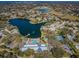 Aerial view of community amenities, including a pool, clubhouse, and lake at 10641 Timber Ln, Port Richey, FL 34668