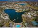 Breathtaking aerial view featuring lake, pier, fountain, pool, and surrounding neighborhood at 10641 Timber Ln, Port Richey, FL 34668