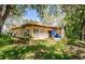 Rear exterior view of a home with a patio and multiple windows allowing natural light to brighten the interior at 10641 Timber Ln, Port Richey, FL 34668