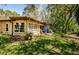 Lush backyard featuring a well-maintained lawn and a cozy patio area perfect for outdoor relaxation at 10641 Timber Ln, Port Richey, FL 34668