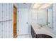 Bathroom features a vanity with sink, mirror, and floral wallpaper at 10641 Timber Ln, Port Richey, FL 34668