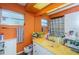 Colorful bathroom featuring vintage tile and an orange wall color at 10641 Timber Ln, Port Richey, FL 34668