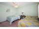 Bright bedroom featuring twin beds and a ceiling fan, creating a cozy retreat at 10641 Timber Ln, Port Richey, FL 34668