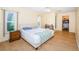 Bright bedroom with laminate floors, a large window, and ample natural light at 10641 Timber Ln, Port Richey, FL 34668