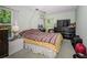 Bedroom with warm light, a comfortable bed, and ample storage, providing a serene and inviting space at 10641 Timber Ln, Port Richey, FL 34668