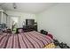 Cozy bedroom featuring a comfortable bed, modern dresser, and ample natural light at 10641 Timber Ln, Port Richey, FL 34668
