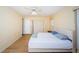 Bedroom with laminate floors, fan, and large window providing natural light at 10641 Timber Ln, Port Richey, FL 34668
