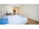 Bedroom featuring laminate floors, a desk area, and a walk-in closet at 10641 Timber Ln, Port Richey, FL 34668