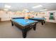 Spacious billiard room featuring three pool tables and ample space for recreation at 10641 Timber Ln, Port Richey, FL 34668