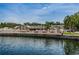 Waterfront view of the community pool area, showcasing seating and recreational space near the lake at 10641 Timber Ln, Port Richey, FL 34668