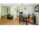 Inviting dining area featuring a mirrored wall, rustic table setting, and charming vintage-style lighting fixture at 10641 Timber Ln, Port Richey, FL 34668