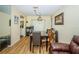 A view of the dining room featuring a dining table, chairs, and wood flooring at 10641 Timber Ln, Port Richey, FL 34668