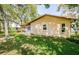 Well-maintained home exterior showcasing clean lines and a tidy yard with mature tree shade at 10641 Timber Ln, Port Richey, FL 34668