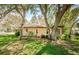 Inviting single-story home nestled beneath mature trees, creating a serene and private atmosphere at 10641 Timber Ln, Port Richey, FL 34668